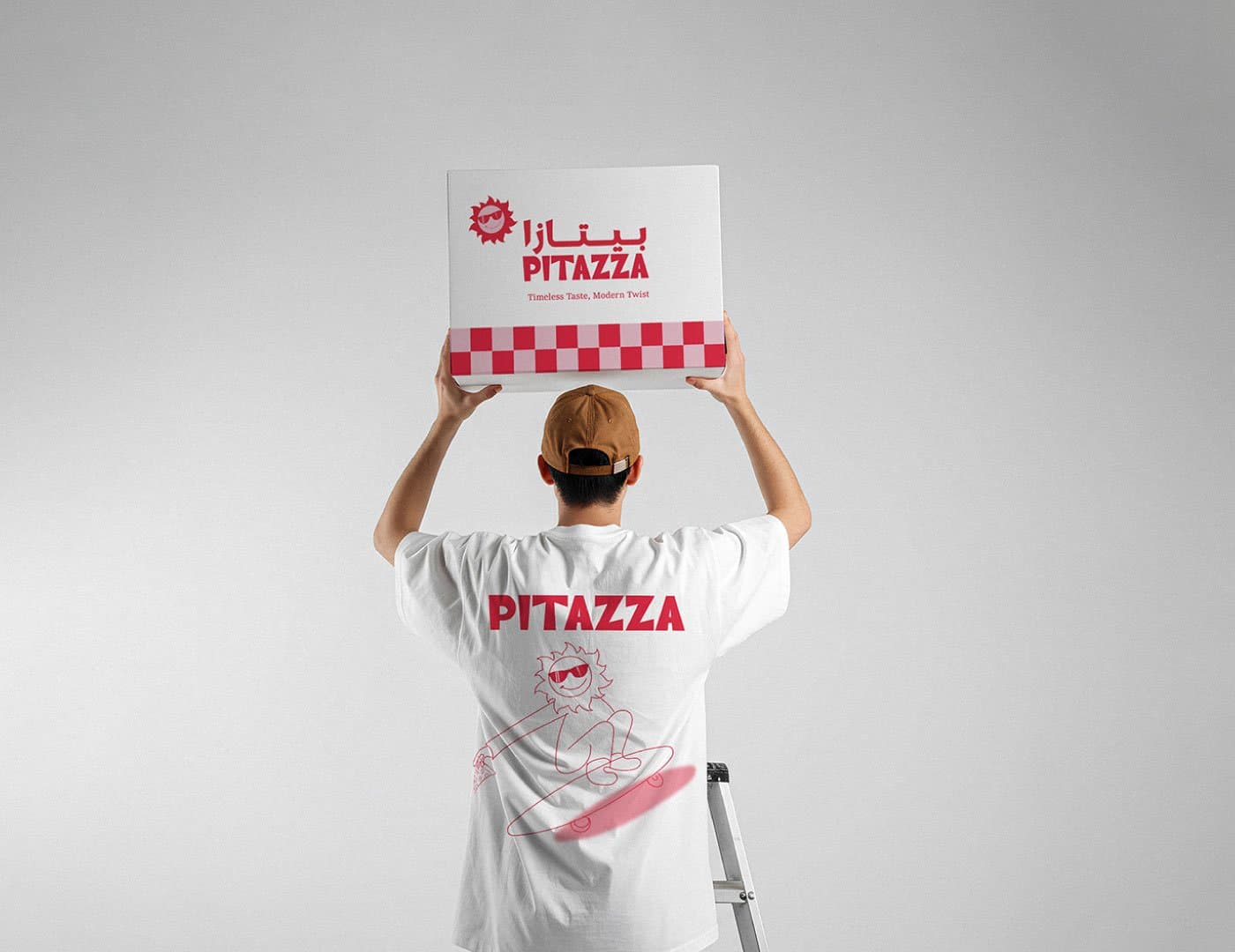 PITAZZA brand identity mockup featuring branded apparel and pizza box packaging with a playful mascot