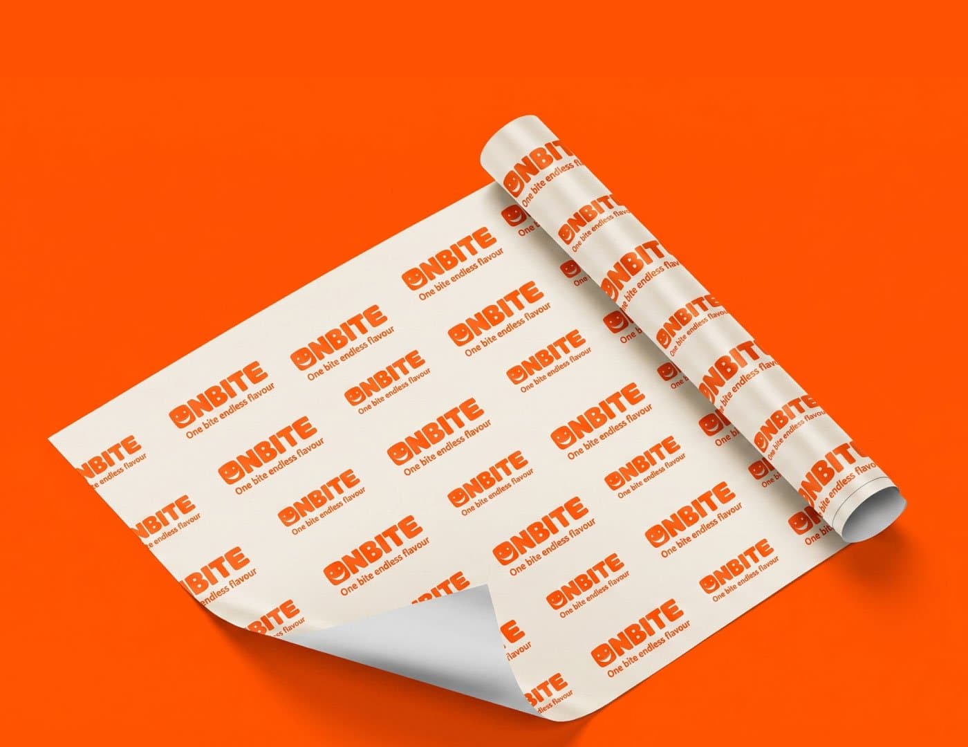 OnBite branded food wrapping paper featuring repeating logo patterns and orange brand identity