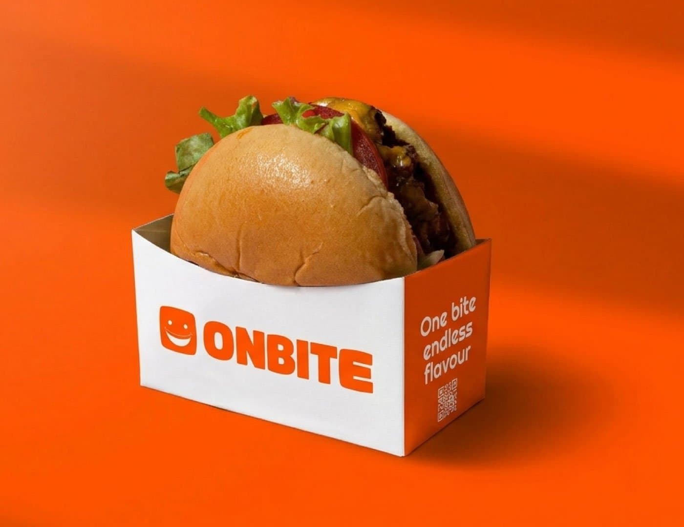 OnBite branded burger packaging featuring a fresh burger served in a custom orange and white food box