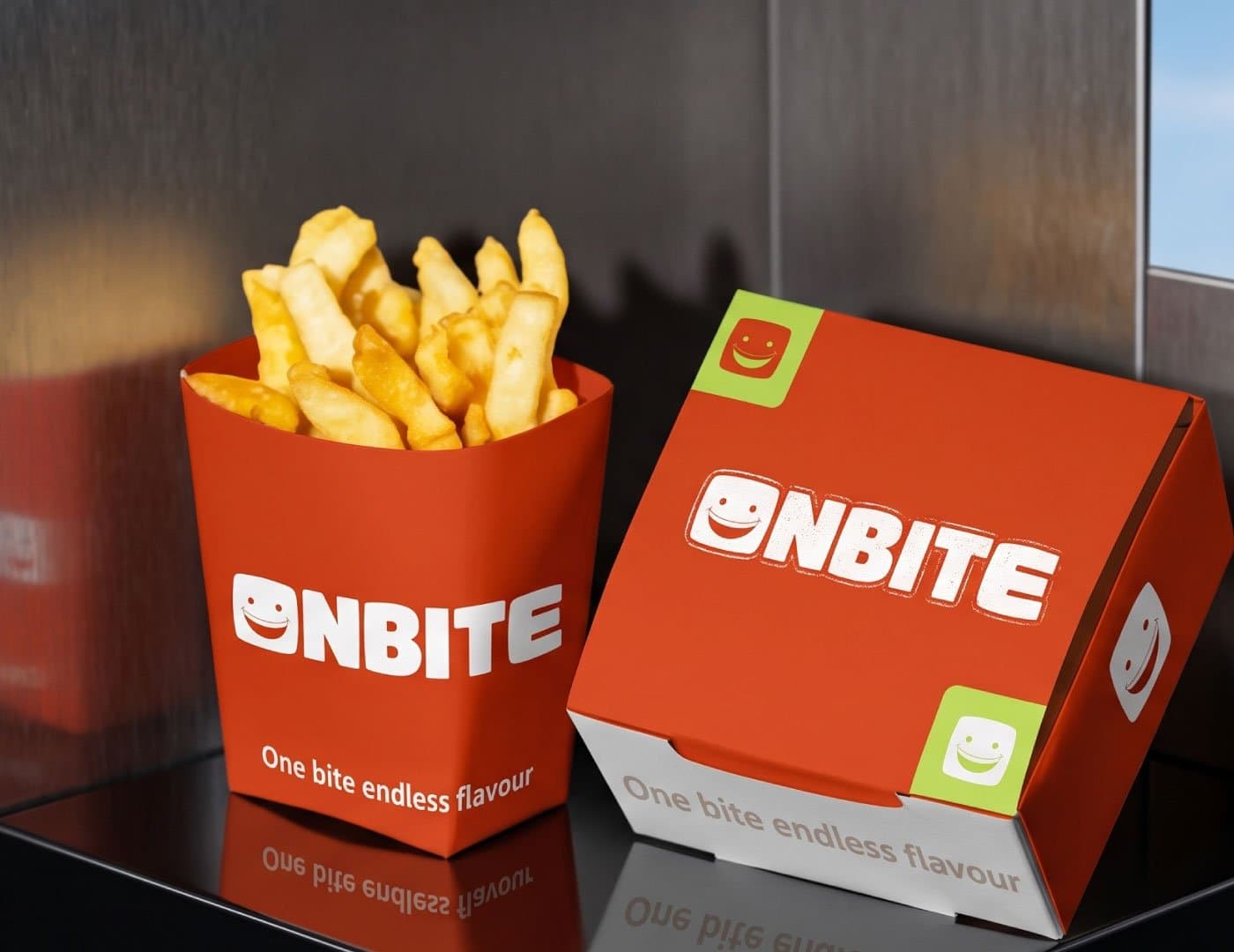 ONBITE food packaging featuring branded fries box and takeaway packaging in orange and white